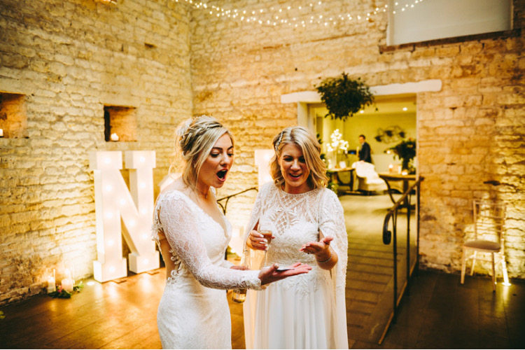 Richard parsons magician in Gloucestershire performing card tricks for same sex couple Jodie and Natasha who are both surprised and delighted