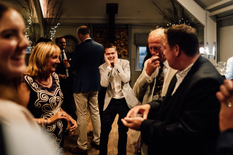 A wedding guest holds his face in utter shock at magician Richard Parsons magic tricks
