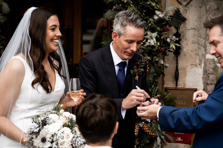 Bride and Groom enjoying close up magic tricks at Manor House Hotel Castle Combe